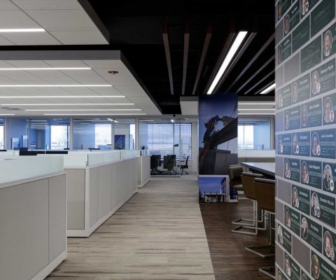 Open cubicle areas with floor-to-ceiling vinyl and magnetic-wrapped columns