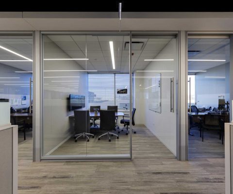 Private offices feature DIRTT glass walls and doors